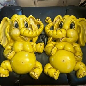 A pair of vintage yellow elephants.